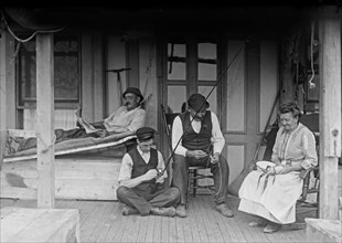 Family on a porch of a home in Broad Channel, Queens ca. 1910-1915
