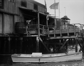 Boat in water outside home in Broad Channel, Queens ca. 1910-1915