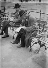 Men sitting on park benches in Union Square ca. 1910-1915