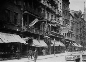 Mott Street in Chinatown, New York City. Church of the Transfiguration in the background and the Port Arthur restaurant at 7-9 Mott Street ca. 1910-1915