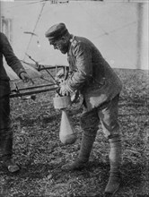 German soldier attaching a bomb to an airplane during World War I ca. 1915