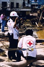 Red Cross worker documenting the damage in Tegucigalpa Honduras caused by Hurricane Mitch ca. September 1989