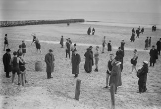 People on the beach at Coney Island on a cold day ca. January 1915