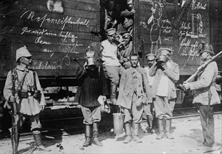 Russian prisoners in East Prussia, standing by a railroad car, drinking from large cups during World War I ca. 1914