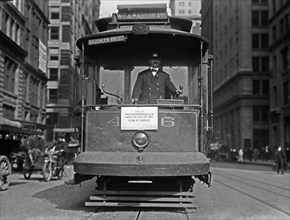 A street car with sign 'This is fire prevention day, clean up rubbish' in New York City - October 9, 1914
