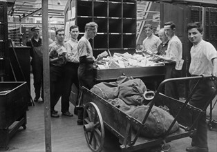Men sorting mail at the Pennsylvania Terminal Post Office (General Post Office Building), now called the James A. Farley Building, located at 421 Eighth Avenue, New York City ca. 1914-1915