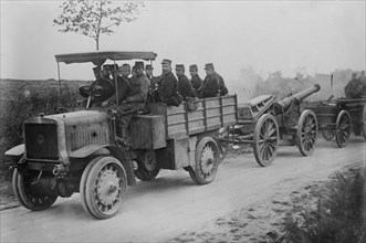 French soldiers in motor tractor which is pulling a large gun along the road at the beginning of World War I ca. 1914-1915