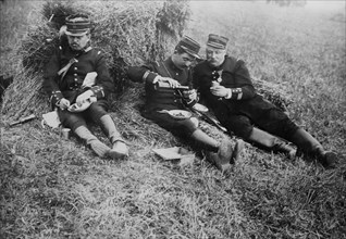 French soldiers eating and drinking wine in a field probably during World War I ca. 1914-1915