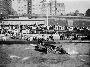 Men enjoying the summer fun of canoe tilting ca. 1910-1915