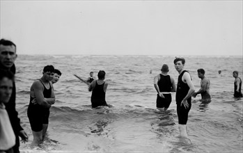 Men playing water baseball ca. 1914