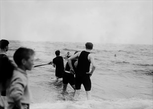 Men playing water baseball ca. 1914
