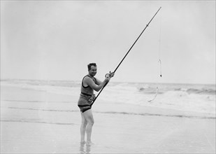 A man surf fishing ca. 1910-1915