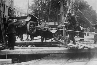 Taxi being pulled from a collapsed section of Rue St. Augustin in Paris, after a heavy rainstorm on June 15, 1914