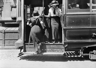 Woman boarding Broadway street car in New York ca. 1910-1915