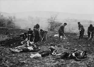 Troops (probably Bulgarians) burying dead soldiers at Çatalca, Turkey during the Balkan Wars ca. 1912-1913