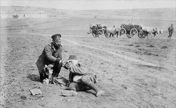 Bulgarian soldier giving water to dying Turk soldier during or after the Siege of Odrin a.k.a. Adrianople(1912–13)