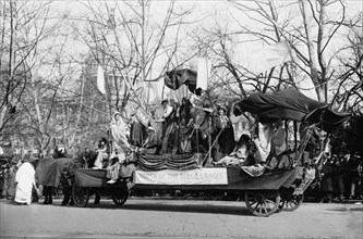 Woman Suffrage Parade held in Washington, D.C., March 3, 1913 showing a float with banner 'Women of the Bible Lands' passing the U.S. Capitol