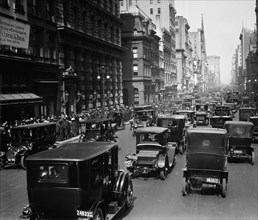 Cars driving down Fifth Avenue in New York City on Easter Sunday 1913