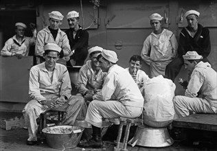 Sailors peeling potatoes on the U.S.S. Arkansas (BB-33) ca. 1910-1915