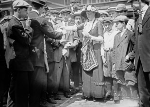 Woman handing out Bull Moose fliers or circulars ca. 1912