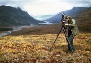 Cameraman filiming at Gates of the Arctic, Alaska ca. 1975