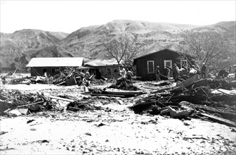 St. Francis Dam flood happened on March 12-13, 1928 in Santa Paula, California. Here, houses piled against each other after the flood as clean up crews are at work—March 18, 1928.