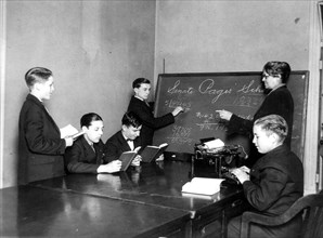 Teacher and five boys in Senate Pages' School - boy typing ca. 1909-1932