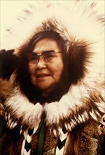 Early 1970s - Eskimo woman with tour group organization in Kotzebue greeting visitors at airport
