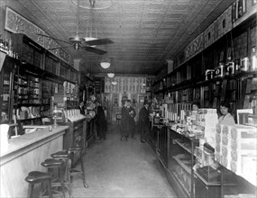 Interior of People's Drug Store, 11th and G Streets, Washington, D.C., with employees behind the counters and customers ca. 1909-1932