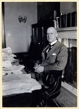 Miles Poindexter, three-quarter length portrait, seated at desk, facing left ca. 1920-1932