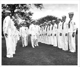 Air Station Barbers Point, Hawaii Original photo caption: 'Rea Admiral S. H. Evans, Commander of the 14th Coast Guard District, inspects personnel attached to the Coast Guard Air Detachment, Barbers P...