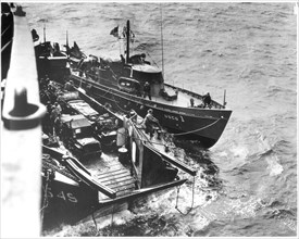 Probably 6 June 1944 - The 83-foot Coast Guard cutter USCG 1 off Omaha Beach on the morning of D-Day, tied up to an LCT and the Samuel Chase