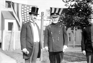 Photo shows General Frederick Dent Grant, commanding officer on Governors Island, with Secretary of War Henry I. Stimson, probably on the occasion of the annual lawn party sponsored by the Army Relief...