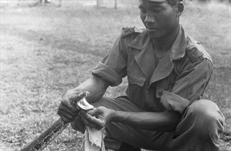KNIL soldier holds the head of a snake; Date January 1949; Location Indonesia, Dutch East Indies