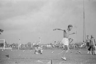 Competitors throwing discus; April 6, 1947; Location: Indonesia, Dutch East Indies