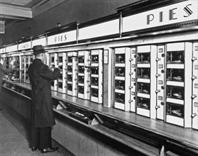 1930s New York City - Man taking a pie from an Automat, 977 Eighth Avenue, Manhattan ca. 1936