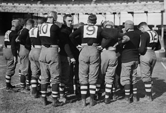 Vintage Football Game - Huddle of football players for the Brown University football team - October 24, 1914