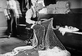 Mending Tennis Net -- Sailor's Snug Harbor ca. 1910-1915