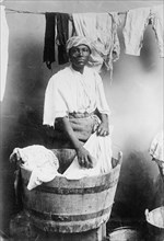 West Indian woman washing clothes in a tub ca. 1910-1915
