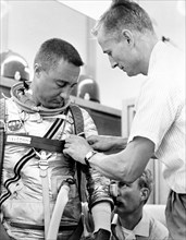 (1961) Astronaut Virgil I. (Gus) Grissom, pilot of the Mercury-Redstone 4 (MR-4) spaceflight, suits up for MR-4 simulation training. Assisting is suit technician Joe Schmitt.
