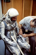 (1961) A NASA suit technician adjusts astronaut Virgil I. (Gus) Grissom's Mercury pressure suit during prelaunch activities at the Florida Space Center.