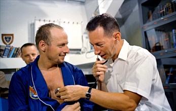 (29 Aug. 1965) Astronaut Charles Conrad Jr. has his heart rate checked by a physician after the Gemini-5 mission.