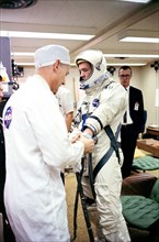 (16 March 1966) Astronaut David R. Scott, pilot of the Gemini-8 spaceflight, in the Launch Complex 16 trailer during suiting up operations for the Gemini-8 mission. NASA suit technician Joe Schmitt he...