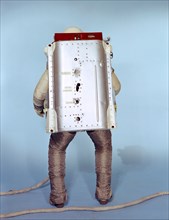 (May 1966) Rear view of the Astronaut Maneuvering Unit (AMU), worn by test subject Fred Spross, Crew Systems Division. The Gemini spacesuit, backpack and chest pack comprise the AMU, a system which is...
