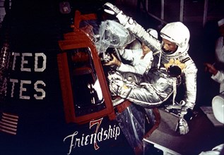 Astronaut John Glenn enters the Mercury spacecraft, Friendship 7, prior to the launch of MA-6 on February 20, 1961 and became the first American who orbited the Earth.