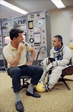 (23 March 1965) Astronaut Virgil I. Grissom (right), the command pilot of the Gemini-Titan 3 three-orbit mission, is shown with astronaut Walter M. Schirra Jr. in the ready room at Pad 16.