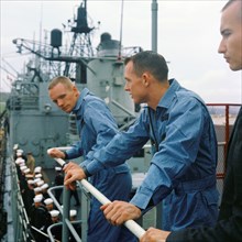 (17 March 1966) Astronauts David R. Scott (left), Gemini-8 pilot, and Neil A. Armstrong, command pilot, stand on the deck of the destroyer USS Leonard F. Mason upon its arrival at Nahs, Okinawa