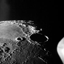 20 Jul 1969 - Apollo 11 oblique view of large crater Theophilus located at the NW edge of the Sea of Nectar on the lunar nearside. Theophilus about 60 statute miles in diameter. The smooth area is Mar...