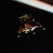 (20 July 1969) The Apollo 11 Lunar Module (LM), in a lunar landing configuration, is photographed in lunar orbit from the Command and Service Modules (CSM).