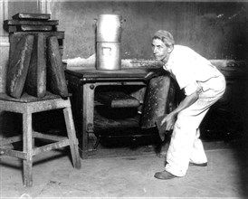 Charles C. Trevey baking huge loaves for the bears at the National Zoo, Washington, D.C. August 1922